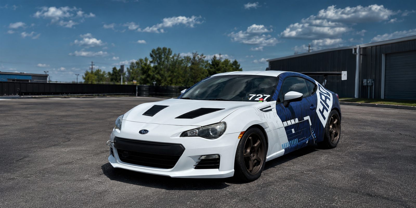HRD 727 race car in the paddock